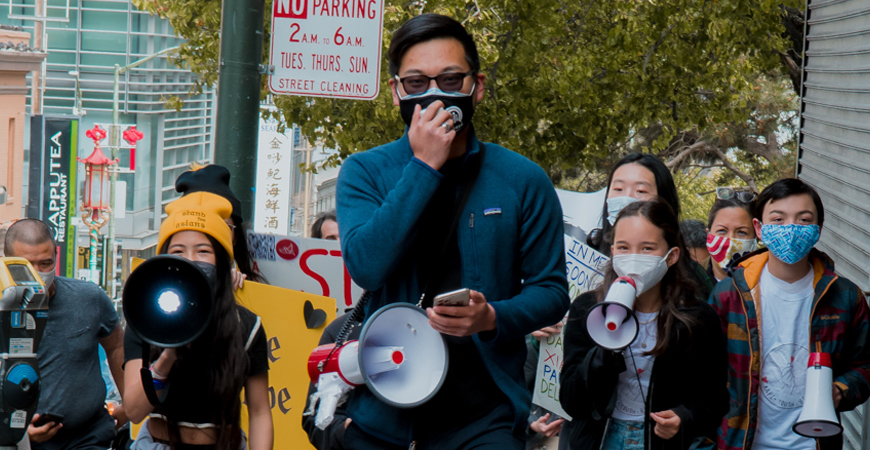 People participate in a march against anti-Asian hate.