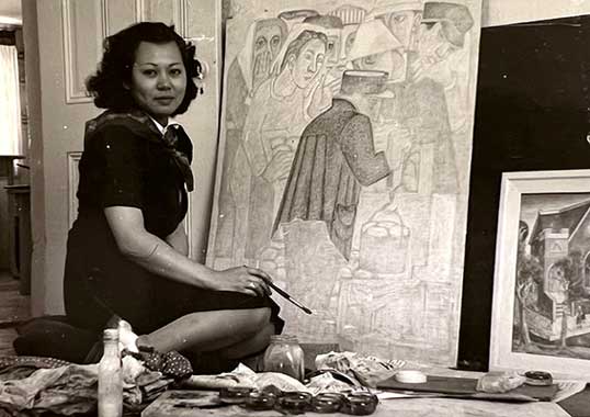 Mine Okubo painting in studio in 1940