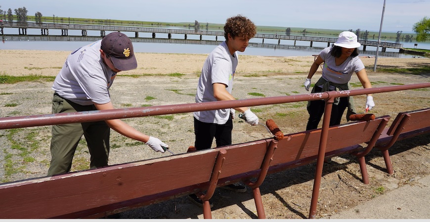 Volunteers take part in a painting project at Lake Yosemite.