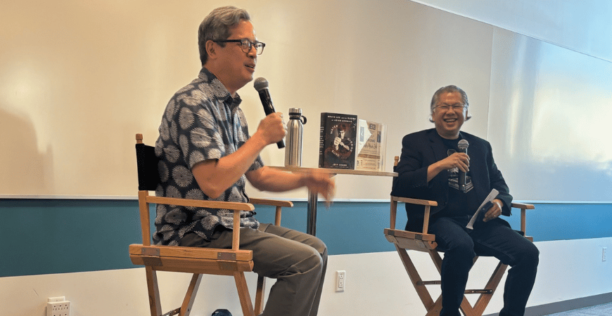 Chef Jeff Chand and event moderator Bayani Jol Manilay seated at the front of the room. Chang is speaking into a microphone. 