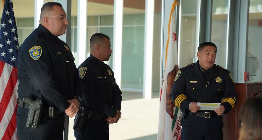 Officers Brian Carbaugh and Enrique Rodriguez receive awards from UC Merced Police Chief Chou Her.
