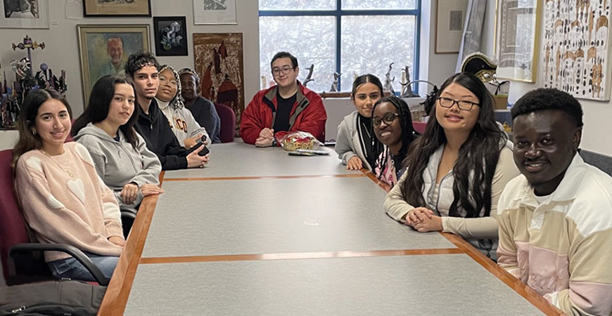Students from UC Merced writing class gather at table at Merced Multicultural Arts Center